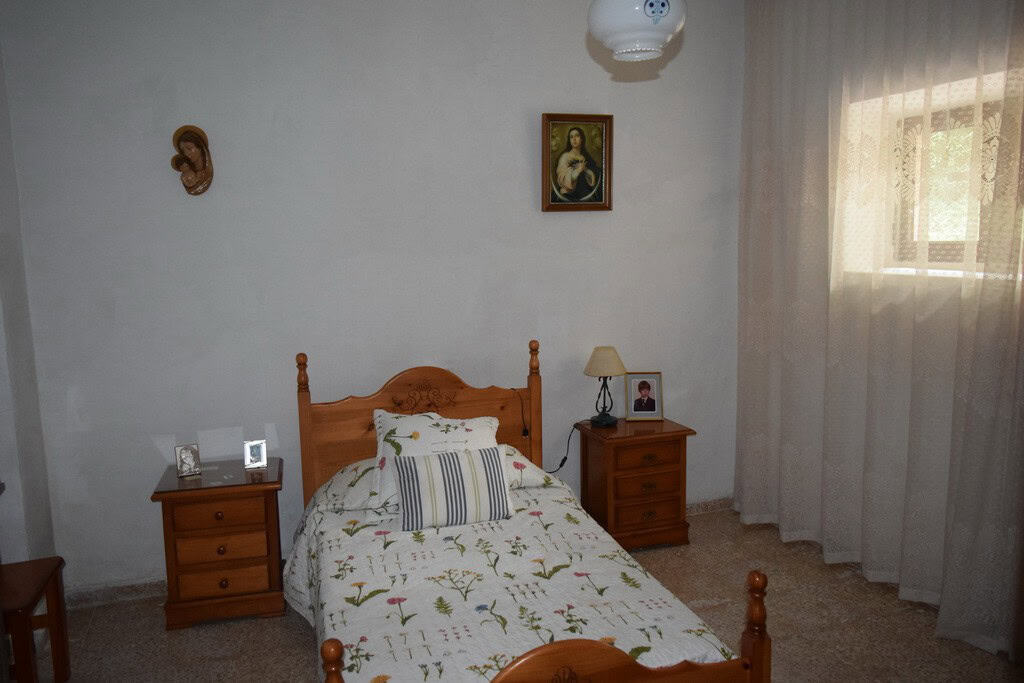 Cozy bedroom in a village property located in Cortes de Baza, Granada, featuring traditional decor a.