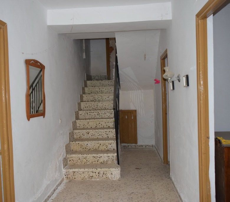 Charming village property interior with stairs and simple decor in Cortes de Baza, Granada.
