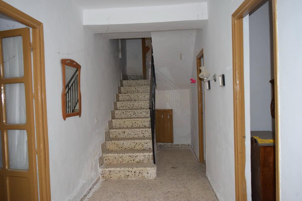 Charming village property interior with stairs and simple decor in Cortes de Baza, Granada.