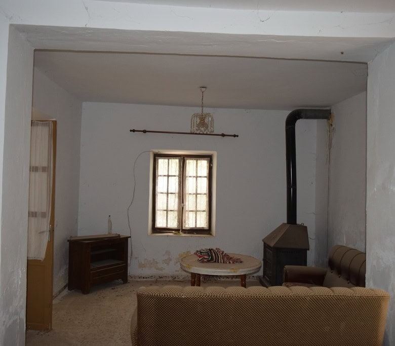 Cozy interior of a village property in Cortes de Baza, Granada, featuring a simple living room with.