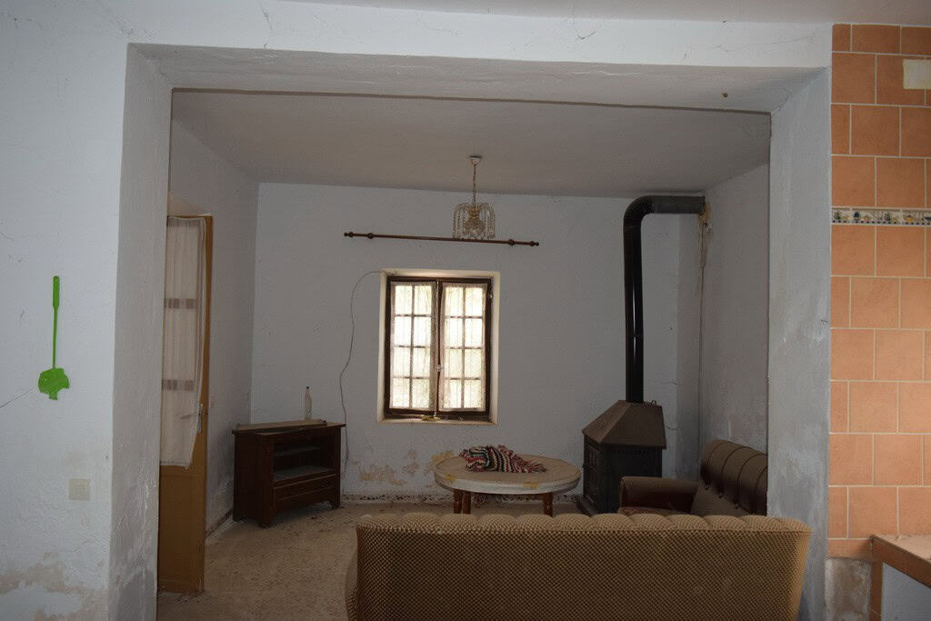 Cozy interior of a village property in Cortes de Baza, Granada, featuring a simple living room with.
