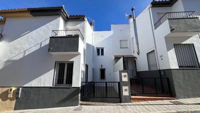 Modern town house in Caniles, Granada with white exterior and balconies.