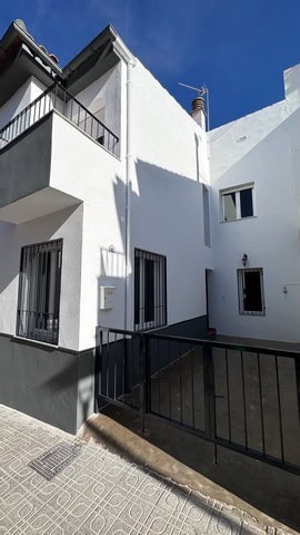 Town House in Caniles, Granada with white exterior walls and balconies.