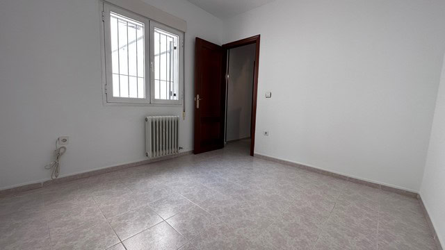 Interior view of a clean, empty town house room in Caniles, Granada.