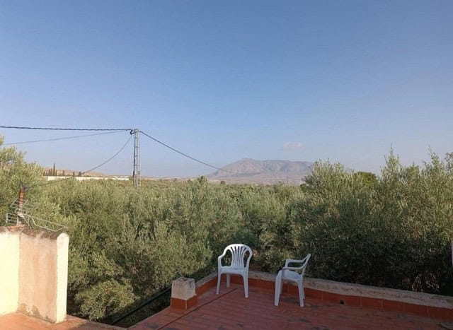 Rural property with terrace overlooking lush greenery and distant mountains in Baza, Granada. Perfec.