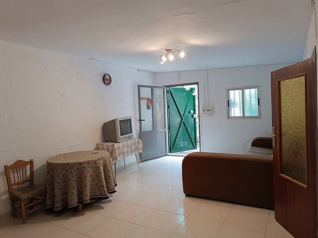Charming rural property interior in Baza, Granada, featuring simple furnishings and natural light.