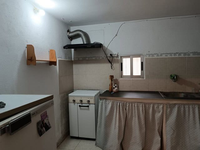 Rural property kitchen in Baza, Granada with simple appliances and cozy interior.