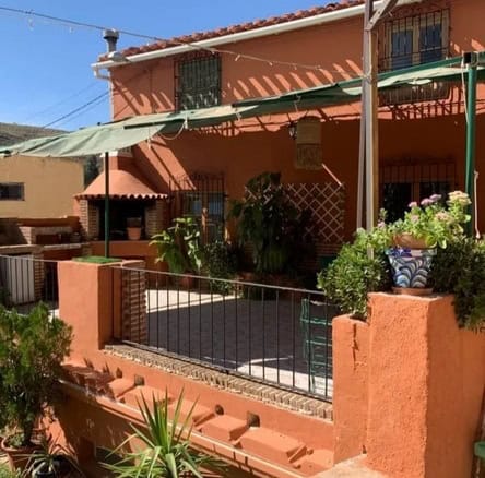 Town House in Cullar, Granada with a cozy outdoor terrace and lush plants. Perfect for a comfortable.