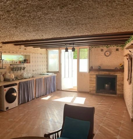 Cozy interior of a town house in Cullar, Granada, featuring a spacious living area with a fireplace.