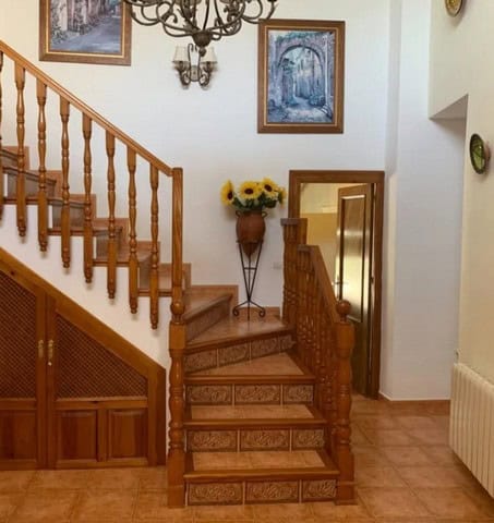 Town House interior with wooden staircase and decorative artwork.