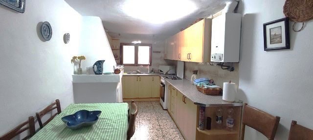 Charming rural home kitchen in Seron, Almeria with simple furnishings and natural light.