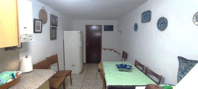 Charming interior of a rural property in Seron, Almeria, featuring a simple dining area with traditi.