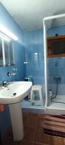 Cozy bathroom in a rural property located in Seron, Almeria, featuring blue tiled walls, a shower, a.