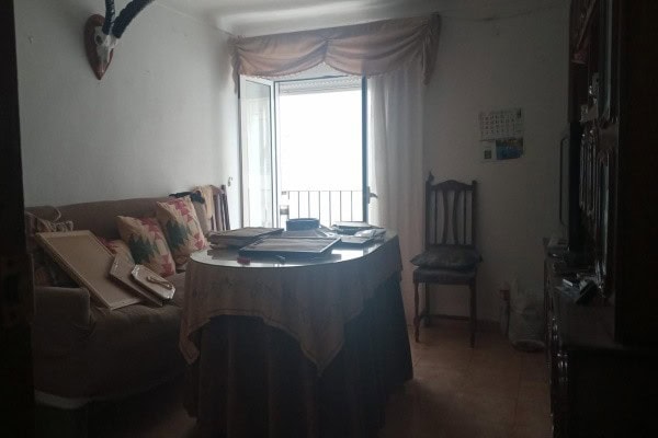 Cozy village home interior with a dining table and seating area in Hinojares, Jaen.