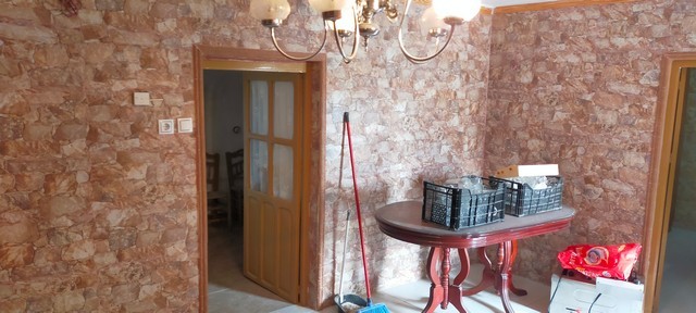 Interior view of a rustic village house with stone walls in Benamaurel, Granada.