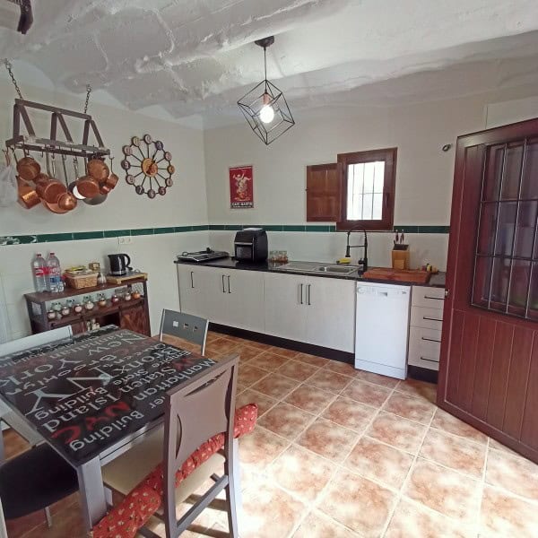 Cozy kitchen in a village property located in Hinojares, Jaen, featuring traditional decor and essen.