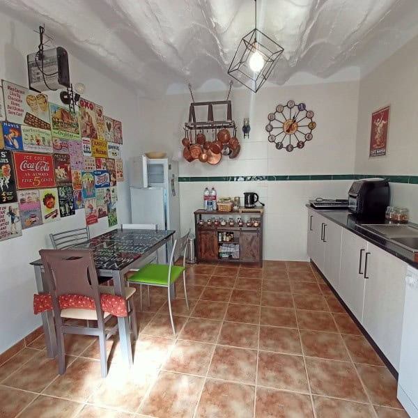 Cozy kitchen with vintage decor and colorful wall art in a traditional village property.