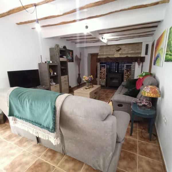 Charming living room in a village property in Hinojares, Jaen, featuring rustic decor and cozy seati.
