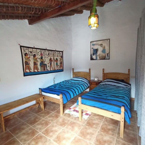 Charming village home with two single beds, traditional decor, and artwork, perfect for a peaceful r.