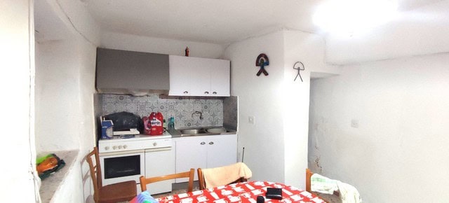 Charming town house interior in Tijola, Almeria, featuring a cozy kitchen and dining area with simpl.