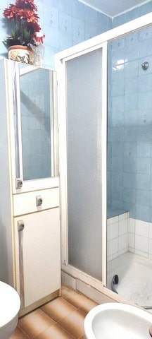 Bright bathroom in Tijola town house, Almeria with shower enclosure and modern fixtures.