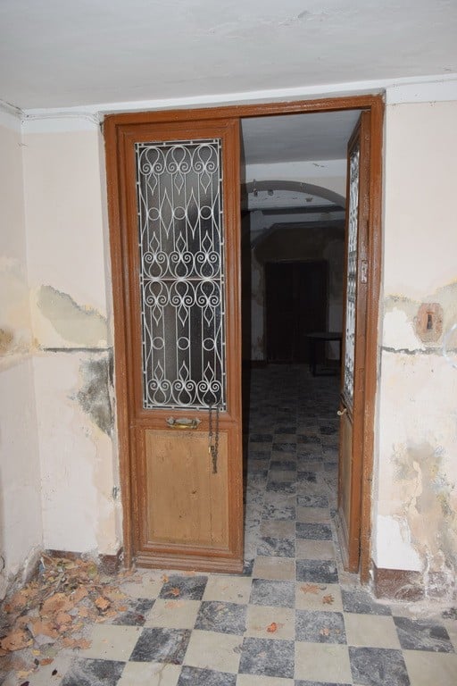 Traditional wooden door with decorative metal grille in Baza, Granada.
