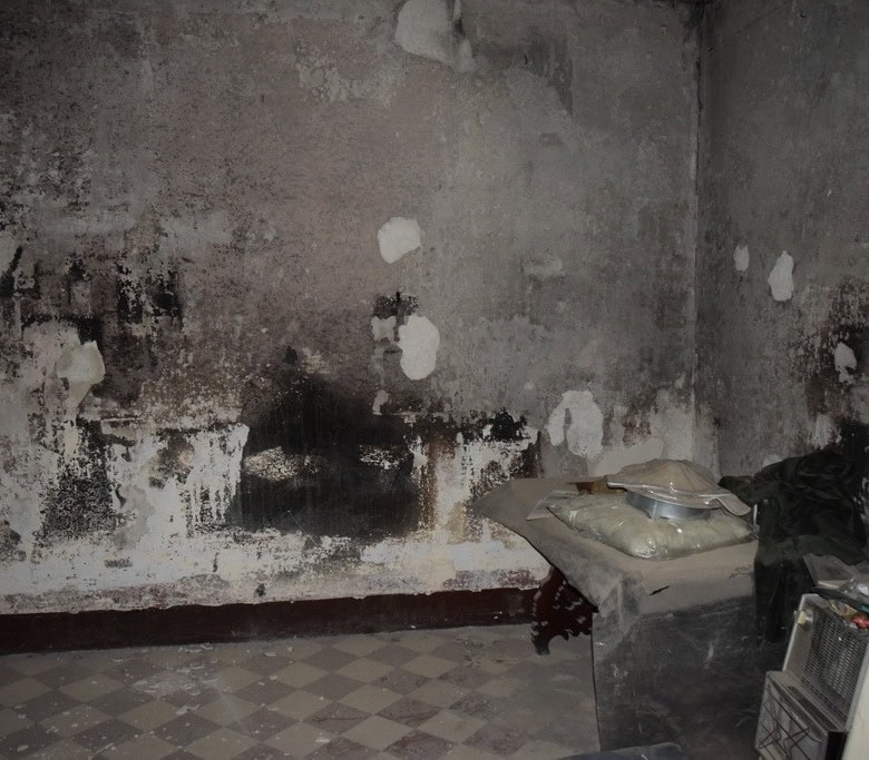 Abandoned interior of a town house in Baza, Granada with damaged walls and old furnishings.