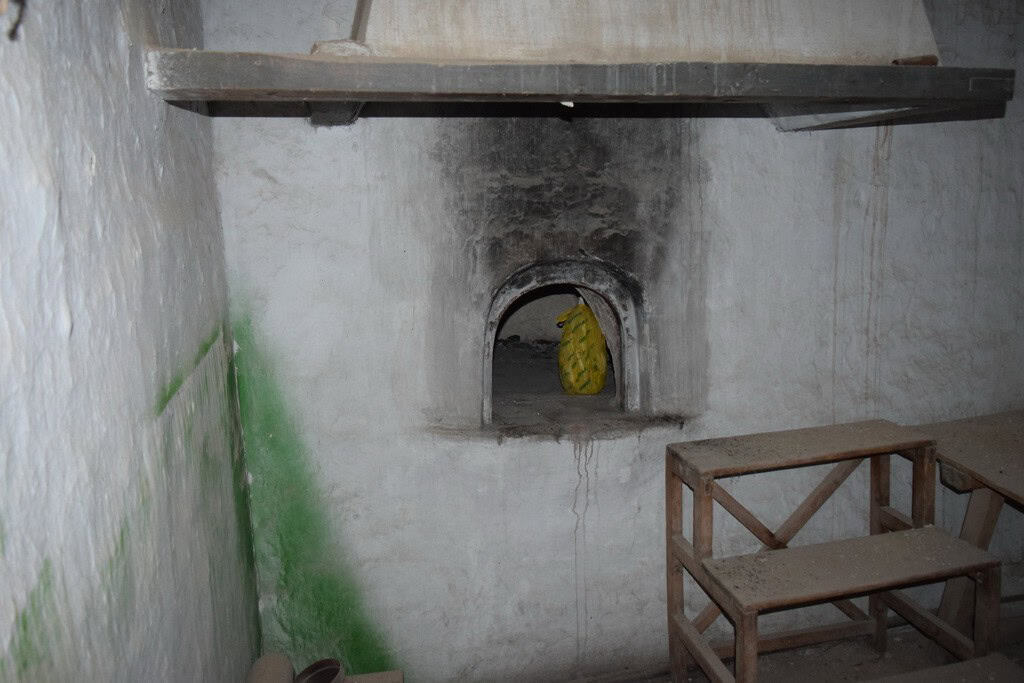 Traditional town house interior in Baza, Granada, with rustic walls and a small arched window.