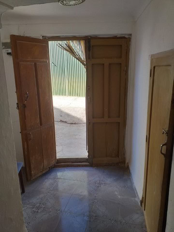 Charming village property entrance with wooden doors in Galera, Granada, offering authentic Andalusi.