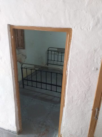 Cozy village home in Galera, Granada featuring a simple bedroom with a metal bed frame.