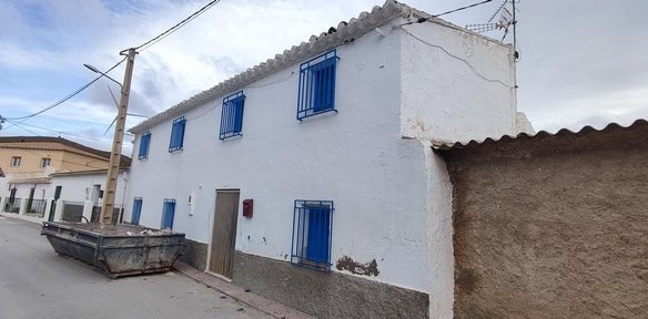 Charming village house in Seron, Almeria with white walls and blue window shutters. Perfect for a pe.