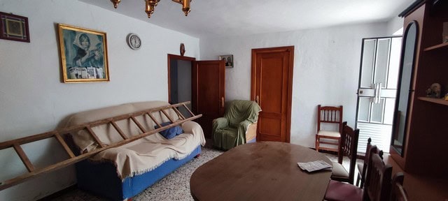 Interior of a traditional village house in Seron, Almeria, featuring simple furnishings and rustic c.