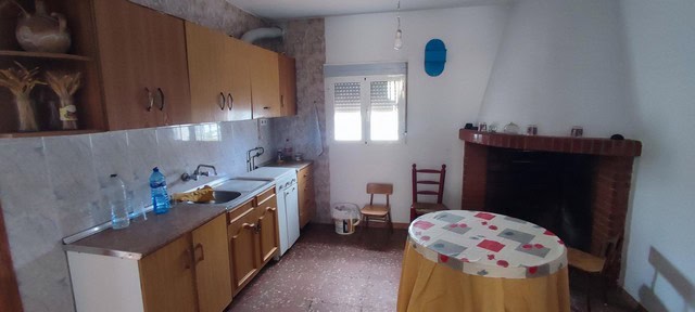 Charming village home kitchen in Seron, Almeria with rustic features and simple furnishings.