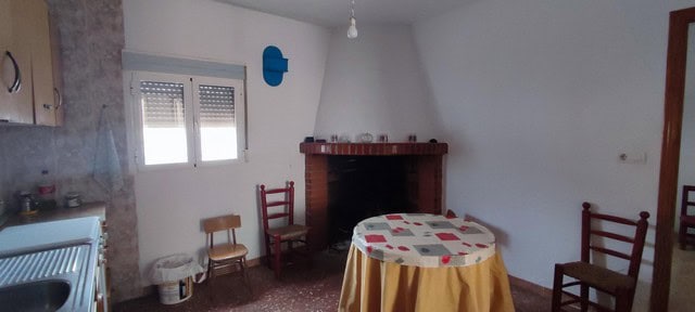 Charming village home interior in Seron, Almeria with simple furnishings and a cozy fireplace.
