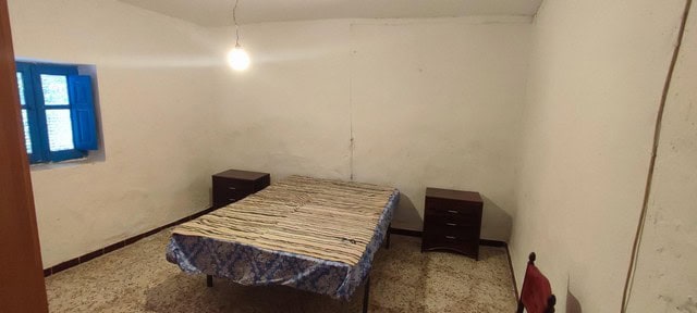 Charming village home in Seron, Almeria, featuring a simple bedroom with basic furnishings. Ideal fo.