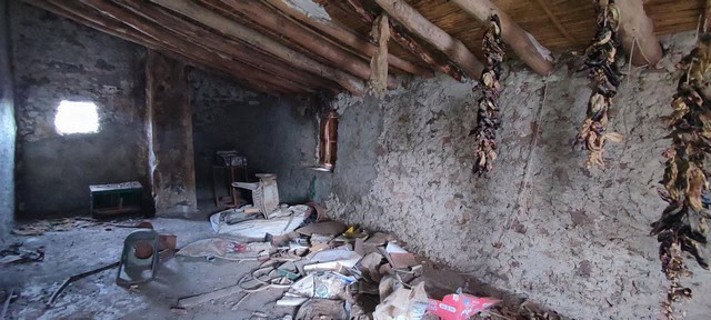 Interior of rustic rural property in Seron, Almeria with unfinished walls and hanging dried herbs.