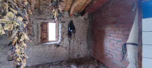 Interior view of a rustic rural property in Seron, Almeria, showing stone and brick walls.