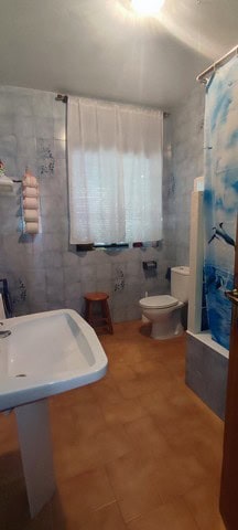 Charming rural home bathroom with simple fixtures and natural light in Cortes de Baza, Granada.