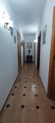 Charming rural property hallway in Cortes de Baza, Granada, featuring white walls, wooden doors, and.