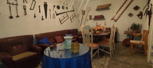 Charming rural home interior with vintage tools on the wall and cozy dining area in Cortes de Baza,.