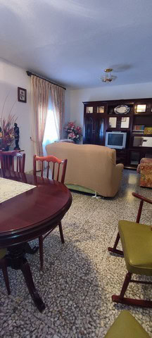 Cozy living room of a town house in Tijola, Almeria, featuring traditional furniture, a TV, and natu.