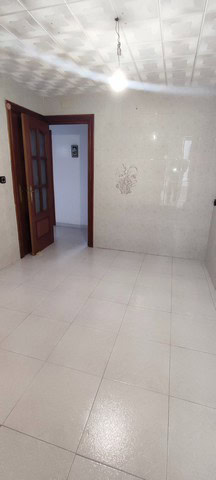 Interior view of a town house in Tijola, Almeria, showcasing a clean, bright room with tiled floors.