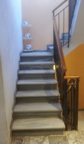 Staircase inside a village property in Seron, Almeria, showing marble steps and a wooden handrail.