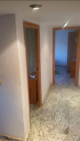 Interior view of village property in Seron, Almeria with wooden door frames and marble flooring.