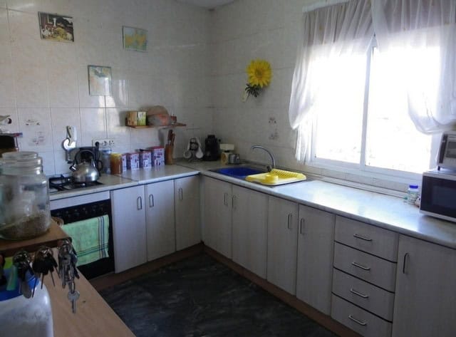 Kitchen with white cabinets and natural light in Seron, Almeria village property.