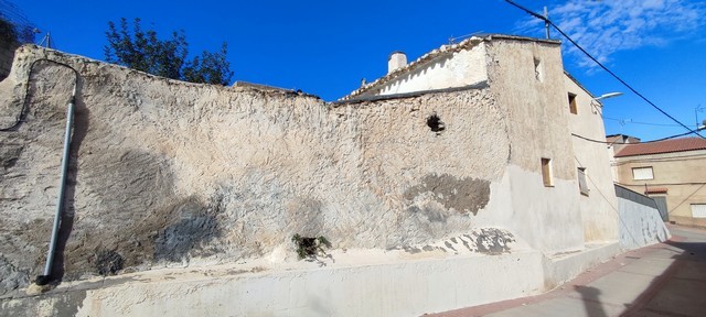 Traditional town house in Tijola, Almeria with rustic stone walls and small windows.