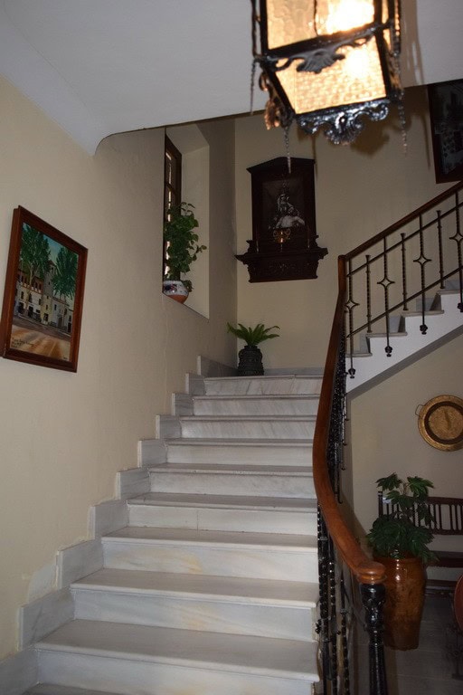 Charming interior staircase of a town house in Baza, Granada, showcasing traditional decor and elega.