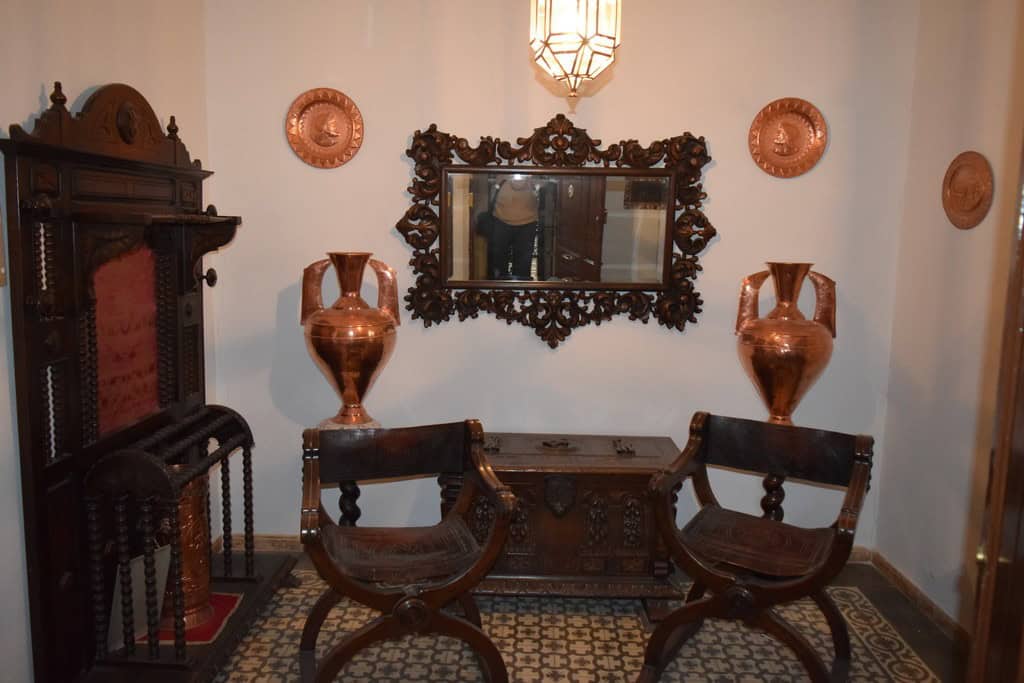 Charming interior of a town house in Baza, Granada featuring vintage furniture, decorative vases, an.