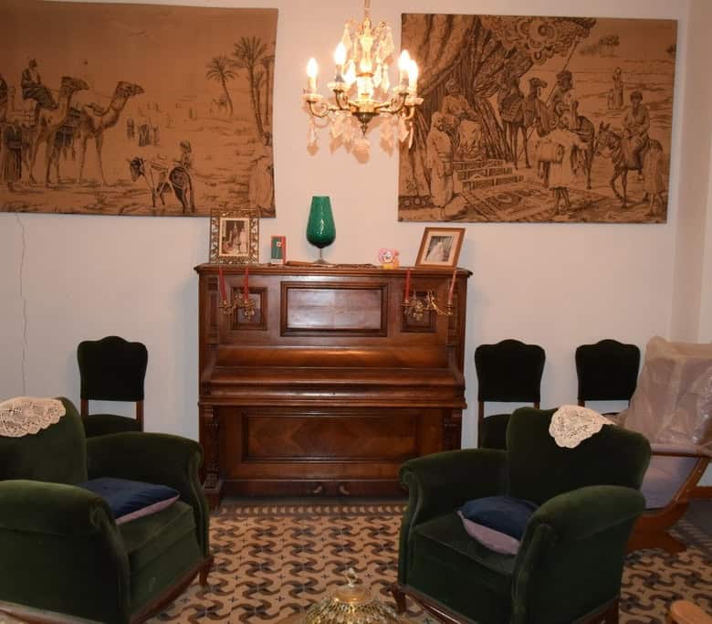 Charming living room of a town house in Baza, Granada, featuring vintage furniture and classic decor.