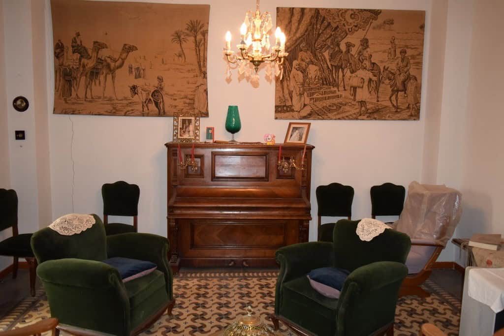 Charming living room of a town house in Baza, Granada, featuring vintage furniture and classic decor.